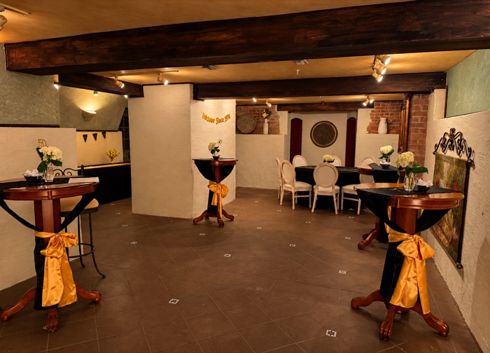Cocktail tables dressed in black and gold in the Cellars